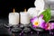 spa background of orchid dendrobium, green leaf Calla lily, candles, towels and beads on zen stones with drops, closeup