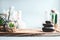 Spa background. Stack of hot stones setting, wellness equipment with succulent plants and white orchid flowers on table at light