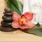 Spa background. White towels on exotic plant, beautiful orchid