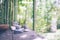 Spa background with woman`s hands and clear water on an old wooden table. Japanese style. Simplicity, Zen, relax.