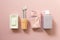 Spa bathroom products. Soap bar, toothbrush, towel, shampoo bottle on pink background