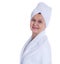 Spa and beauty concept. Aged good looking woman with white towel on her head. UK