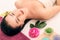 Spa, beauty, people and body care concept - beautiful woman getting face treatment over holidays light background