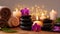 Spa, beauty treatment and wellness background with massage stone, orchid flowers, towels and burning candles