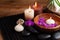 Spa, beauty treatment and wellness background with massage stone, orchid flowers, towels and burning candles