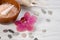 SPA body care concept. Bath salts, seashells, pebbles and pink Orchid flower on white wooden background