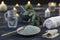 Spa composition on black wooden background. white rolled towels, alight candles, green herbs, eucalyptus clay mask for