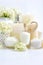 Spa composition with candles, cream, salt and flowers of hydrangea on a white background