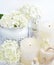 Spa composition with candles, cream, salt and flowers of hydrangea on a white background