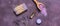Spa composition - lavender sea salt, essential oil, lavender soap, moisturizing cream, and dried lavender flowers, banner. Purple