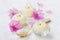 Spa composition with sea salt bath in wooden spoon, pink flowers and burning candles