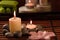 Spa composition with sea salt, candles, soap, shells, creams for face on wooden background.