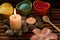 Spa composition with sea salt, candles, soap, shells, creams for face on wooden background.