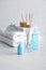 Spa composition with towels and cosmetic products on white wooden table