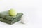 SPA concept. Bath bombs and green towels on light background. Copy space for text