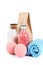 Spa concept of colorful bath salt, a blue towel, paper bag and two pink bath salt balls