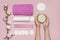 Spa concept. Cosmetic cream for face and body with woman hands, cotton branch, cotton pads, ear sticks, pink towel. Cotton