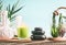 Spa concept with massage equipment: stack of massage stones, aromatherapy candles, herbal stamps setting on wooden table with