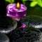Spa concept of zen basalt stones with bead, drops, lilac candle