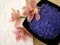 Spa essentials (violet salt, white towel and pink orchids)