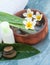 Spa flowers and stones and leaves and oil bottle