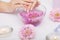 Spa Manicure. Woman Hands With Perfect Natural Healthy Nails Soaking In Aroma Hand Bath. Closeup Of Glass Bowl With Water And Blu