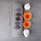 Spa massage setting with rolled towel, thai herbal compress balls and flowers. Flat lay. Top view