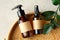 SPA natural organic cosmetics for personal hygiene. Amber glass pump and spray cosmetic bottles, green leaf in rattan container in