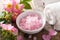 Spa with pink herbal salt and wild rose flowers