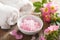 Spa with pink herbal salt and wild rose flowers