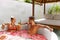 Spa Relax. Couple In Love In Flower Bath Drinking Drinks