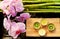 Spa scene with pink orchids, bamboo and candles