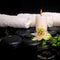 Spa setting of passiflora flower, green branch fern and candle o