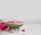 Spa setting with roses and copy space. Rose water bowl for spa and wellness treatments. Rose spa still life