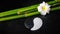 Spa setting of white frangipani flower, symbol Yin Yang and nat