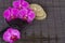 Spa settings with orchids on bamboo mat