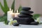 Spa still life with aromatic candles, zen stones, plants and towel. Generative AI