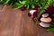 Spa still life with candle, stones and towel decorated fresh green fern