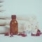 Spa still life with towels, stones, bath oil and candle