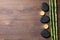 Spa stones, burning candles and bamboo stems on wooden table, flat lay. Space for text