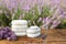 Spa stones, fresh lavender flowers and bath salt on table outdoors, closeup