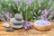 Spa stones, fresh lavender flowers and bath salt on table outdoors, closeup