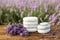 Spa stones, fresh lavender flowers and bath salt on wooden table outdoors