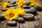 spa stones and a scattering of bright yellow daisies