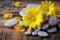 spa stones and a scattering of bright yellow daisies