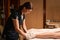 Spa therapist performing exfoliation procedure on client sole