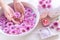 Spa treatment and product for female feet and manicure nails spa with pink flower and rock stone, copy space, select focus,