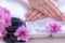 Spa treatment and product for female feet and manicure nails spa with rock and pink flower, copy space, select focus,