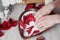 Spa treatment for skin with milk and rose petals, hands are placed in the bowl