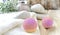 Spa or wellness bodycare setting. Still life image with bath bombs, stones, scrub, towel on wooden background.